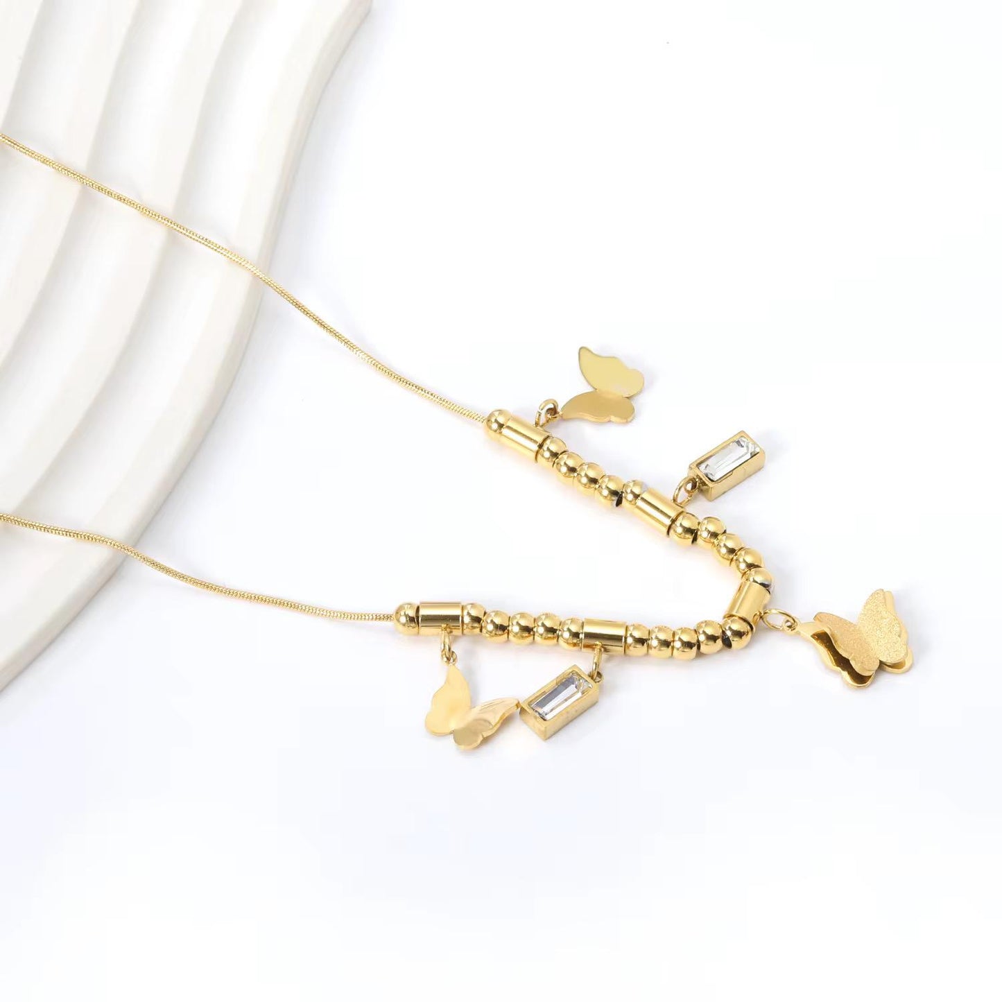 Charming Butterfly & Dangle Charms Necklace, crafted with precision in high-quality gold-plated Stainless Steel.