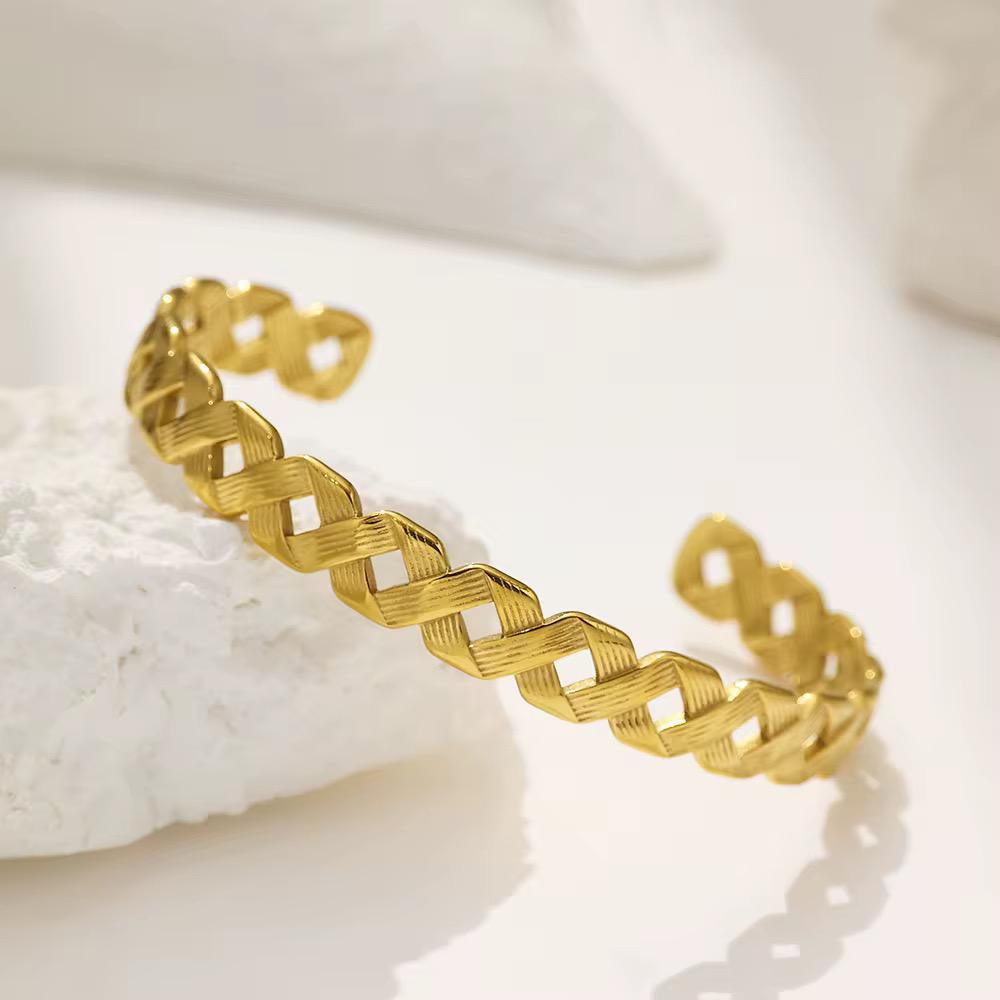 Elegant Gold-Plated Cuff Bangle with Intricate Woven Design.