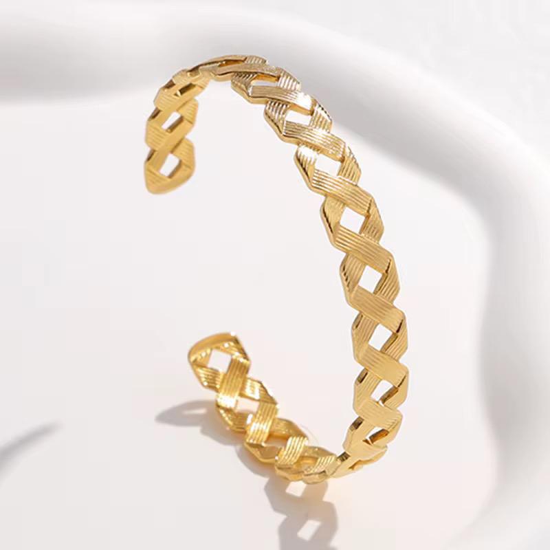 Elegant Gold-Plated Cuff Bangle with Intricate Woven Design.