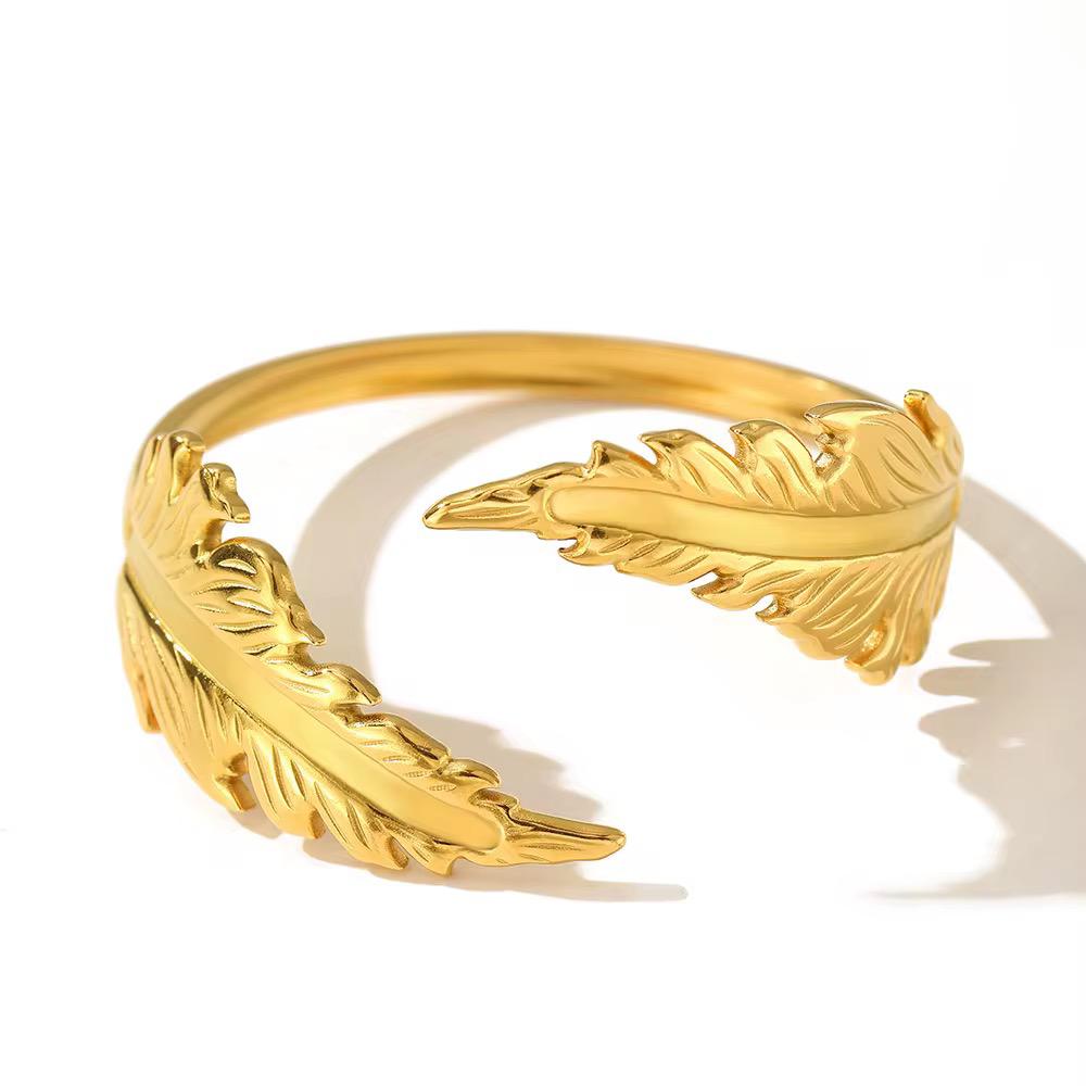 Elegant Gold-Plated Feather Cuff Bangle A nature-inspired piece that blends strength with delicate sophistication.